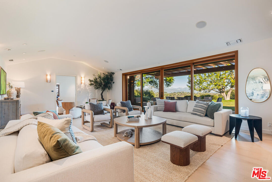 2232 Stradella Road Los Angeles, CA 90077 - Photo 8 of 48 a living room with furniture and a large window