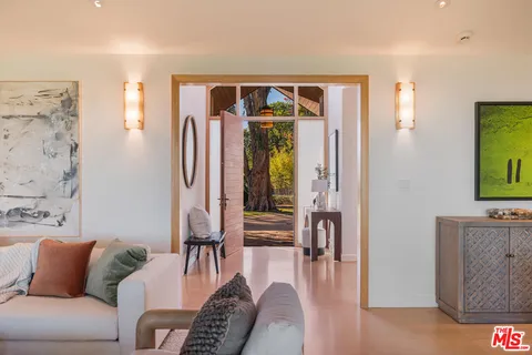 a living room with furniture and a walk in closet