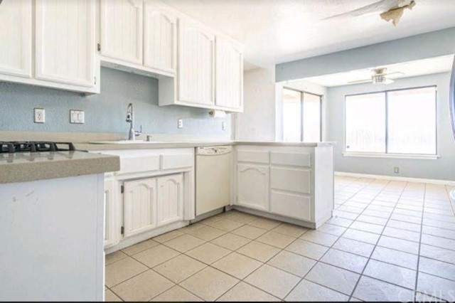 Undisclosed Address Hesperia, CA 92345 - Photo 7 of 14 a kitchen with a stove a sink and a refrigerator
