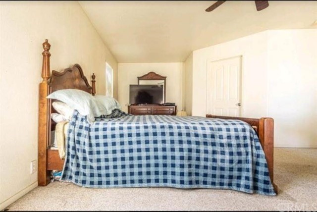 Undisclosed Address Hesperia, CA 92345 - Photo 8 of 14 a bedroom with a bed and window