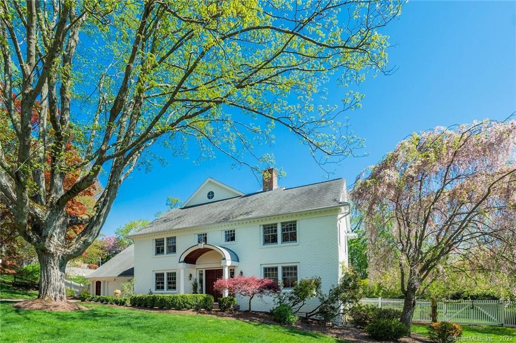 8 Yankee Hill Road Westport, CT 06880 - Photo 1 of 1 a view of a white house with a big yard and large trees