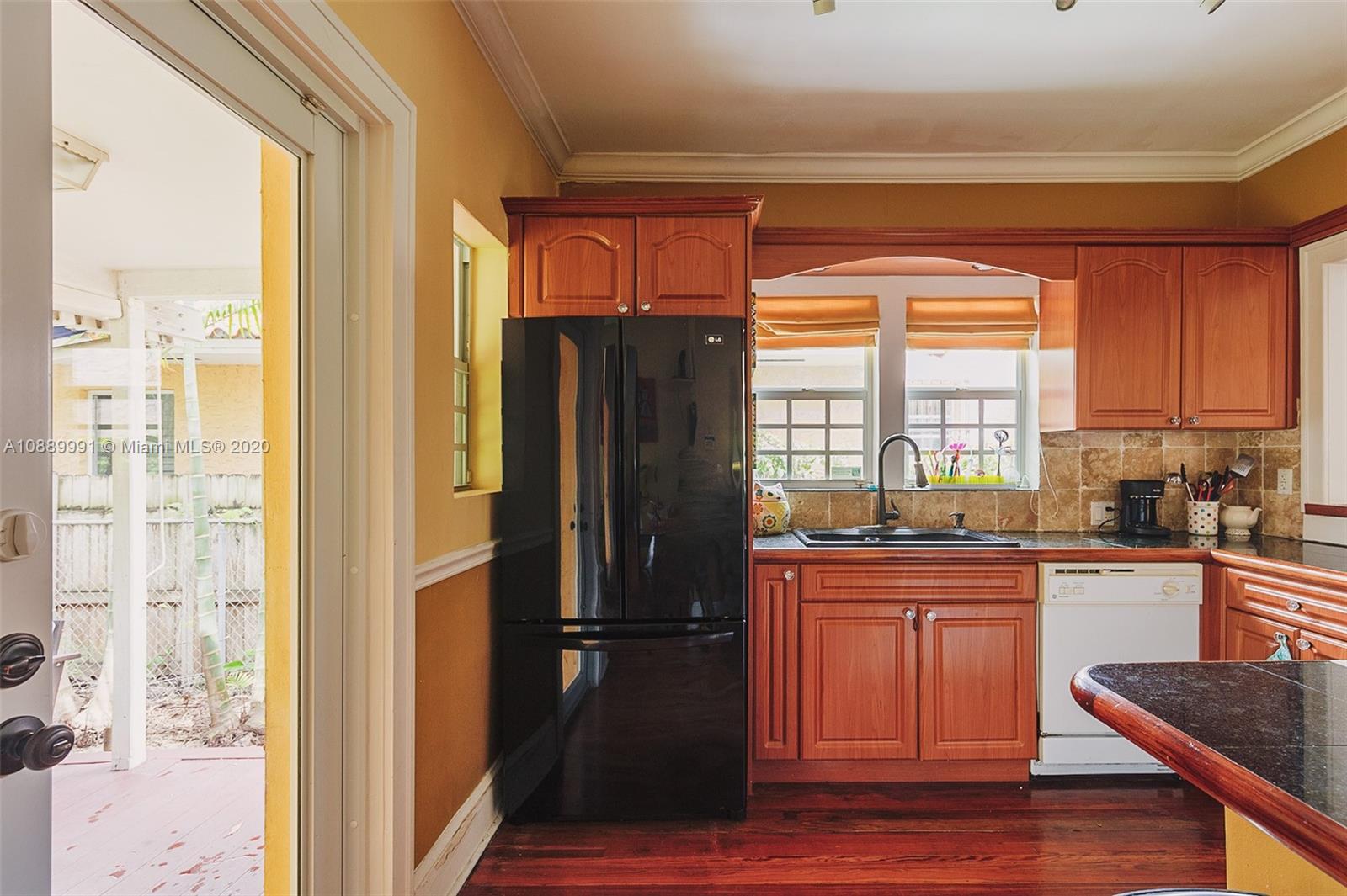 210 Southwest 19th Road Miami, FL 33129 - Photo 14 of 33 a kitchen with a refrigerator a sink and cabinets