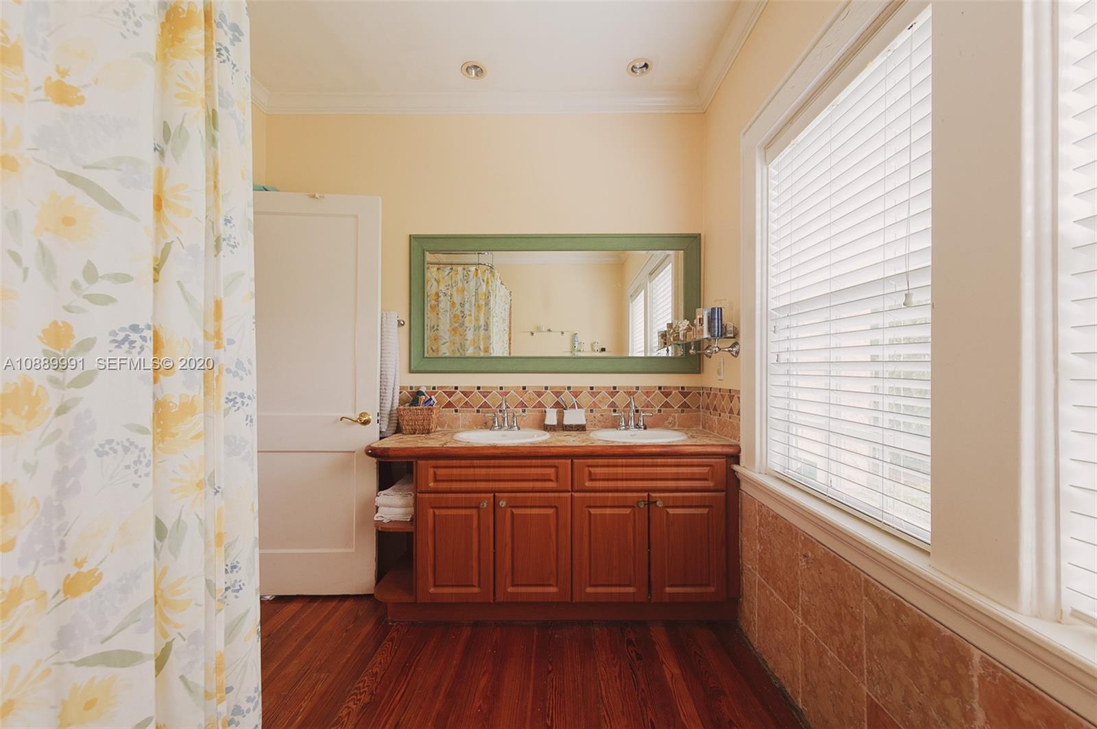 210 Southwest 19th Road Miami, FL 33129 - Photo 17 of 33 a view of a bathroom with a sink and a mirror
