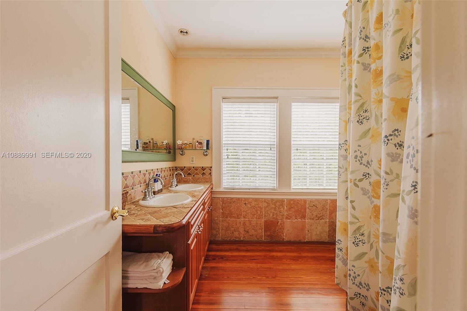 210 Southwest 19th Road Miami, FL 33129 - Photo 18 of 33 a bathroom with a tub a sink and a window