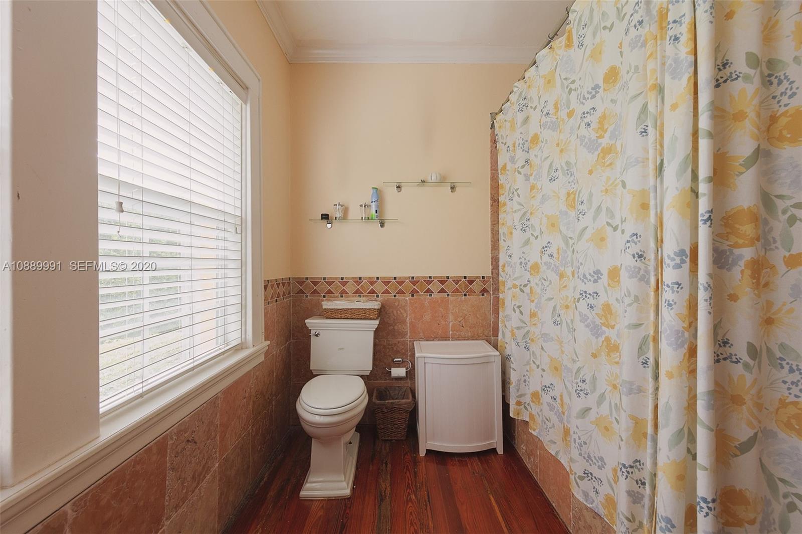 210 Southwest 19th Road Miami, FL 33129 - Photo 19 of 33 a white toilet sitting next to a shower curtain