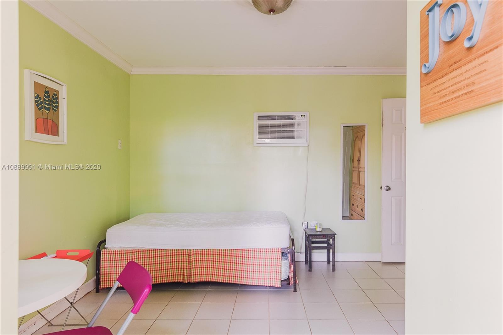 210 Southwest 19th Road Miami, FL 33129 - Photo 25 of 33 a bedroom with a bed and dresser