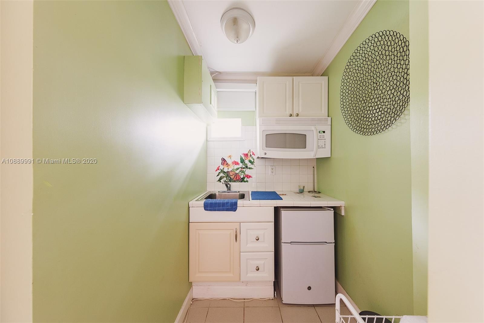 210 Southwest 19th Road Miami, FL 33129 - Photo 26 of 33 a bathroom with a sink a mirror and vanity