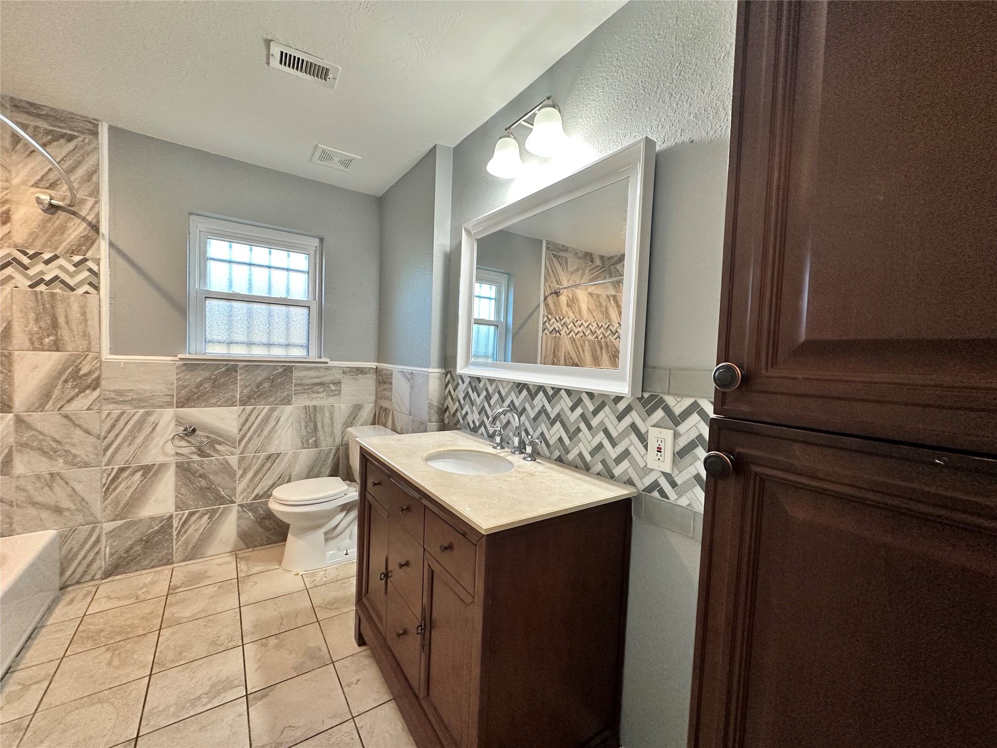 2206 South Houston Road Pasadena, TX 77502 - Photo 10 of 11 a bathroom with a sink toilet and mirror