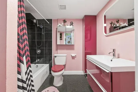 a bathroom with a sink toilet and shower