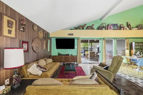a living room with furniture fireplace and a large window