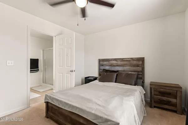 a bedroom with a bed and a chair