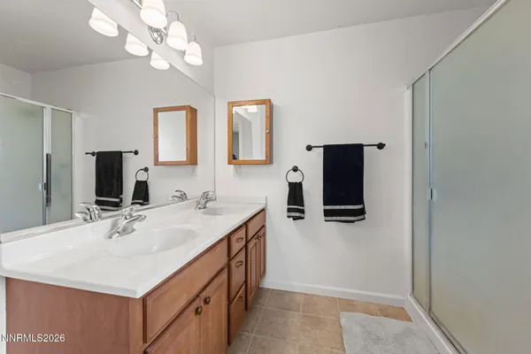 a bathroom with a sink a large mirror and a shower