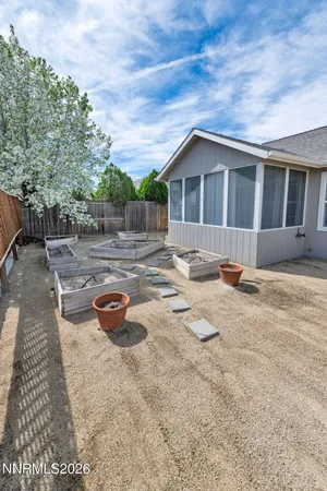 a backyard of a house with table and chairs