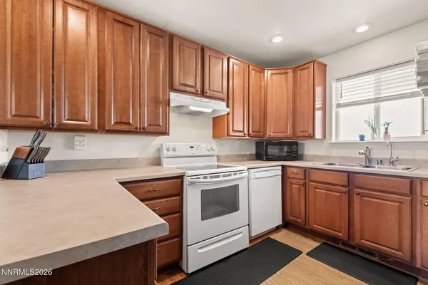 a kitchen with appliances a sink and cabinets