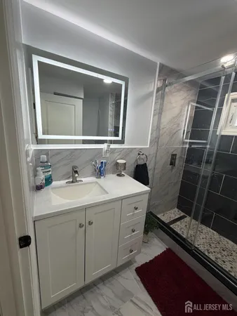 a bathroom with a sink toilet and shower