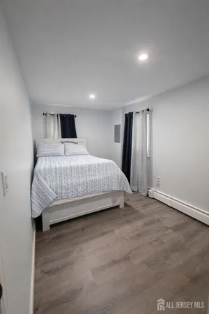 a bedroom with a bed and a night stand