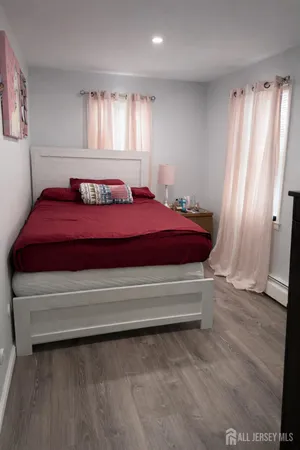 a spacious bedroom with a bed and a window