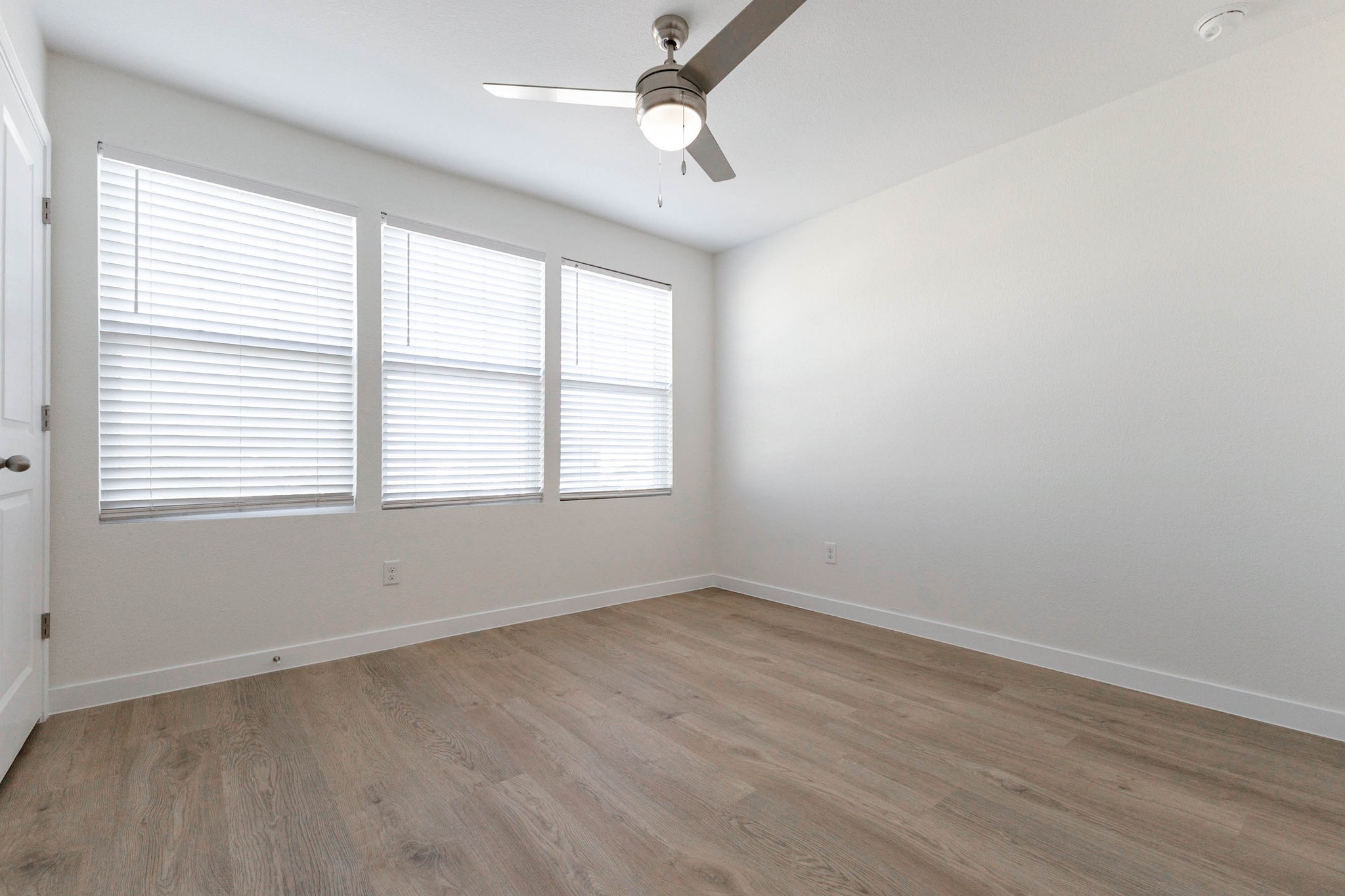 331 Seneca Loop Kyle, TX 78640 - Photo 21 of 29 A wall of three windows fills this secondary bedroom with natural light throughout the day.
