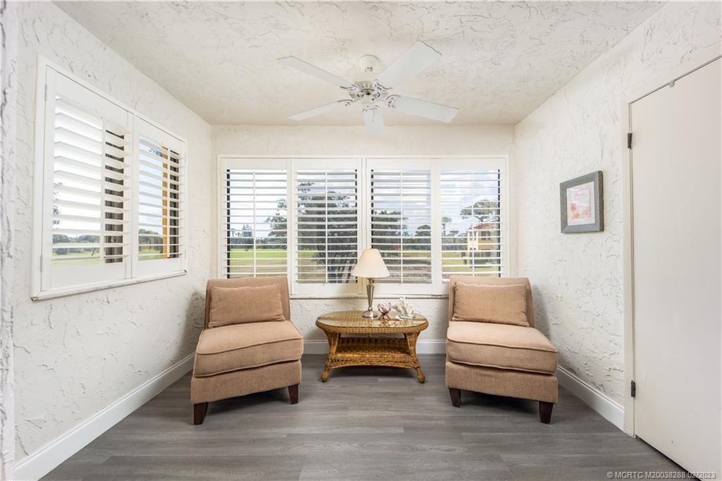 5313 Southeast Miles Grant Road, Unit K209 Stuart, FL 34997 - Photo 12 of 20 a bedroom with furniture and a large window