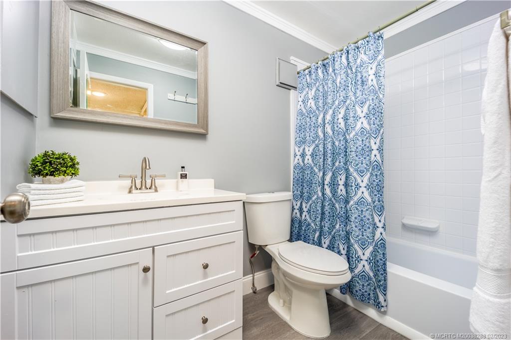 5313 Southeast Miles Grant Road, Unit K209 Stuart, FL 34997 - Photo 15 of 20 a bathroom with a sink a toilet and shower