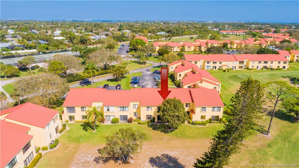 5313 Southeast Miles Grant Road, Unit K209 Stuart, FL 34997 - Photo 20 of 20 an aerial view of residential houses with outdoor space and swimming pool