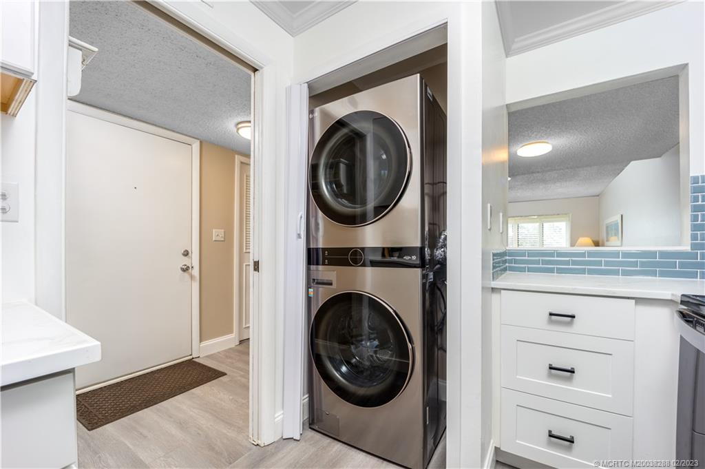 5313 Southeast Miles Grant Road, Unit K209 Stuart, FL 34997 - Photo 7 of 20 a view of a hallway with washer and dryer