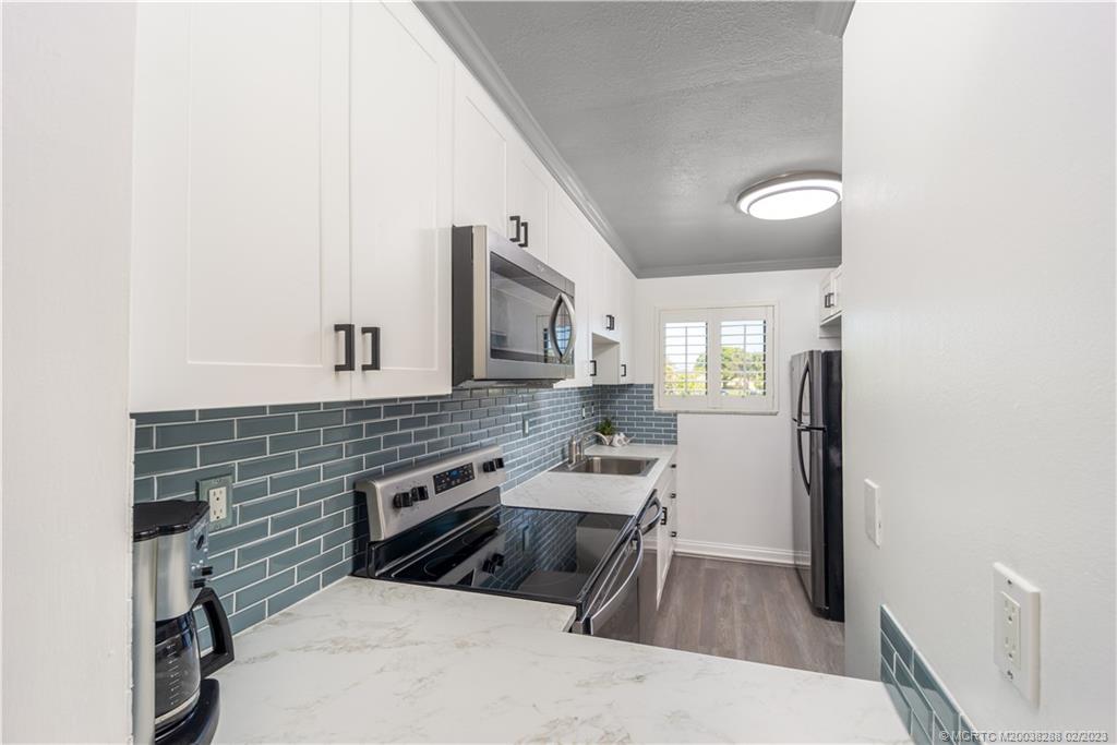 5313 Southeast Miles Grant Road, Unit K209 Stuart, FL 34997 - Photo 8 of 20 a kitchen that has a sink in it