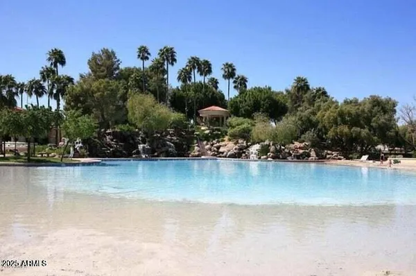 an aerial view of residential houses with outdoor space and lake view