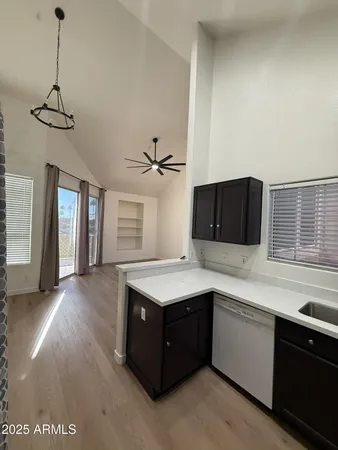 a kitchen with a stove a sink a refrigerator and window