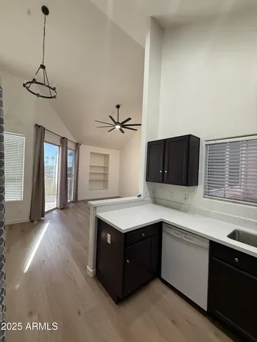 a kitchen with a stove a sink a refrigerator and window