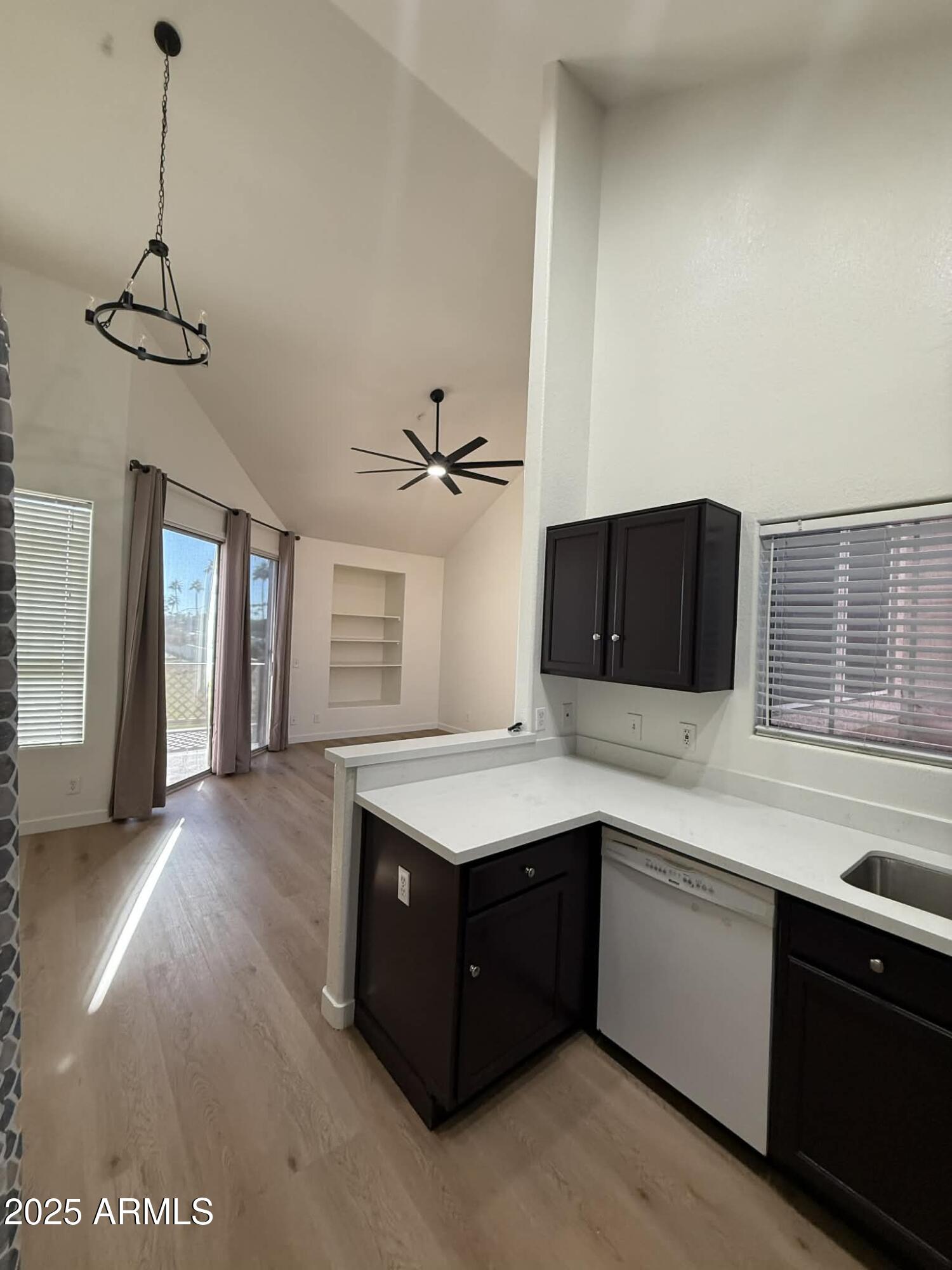 1633 East Lakeside Drive, Unit 65 Gilbert, AZ 85234 - Photo 2 of 12 a kitchen with a stove a sink a refrigerator and window