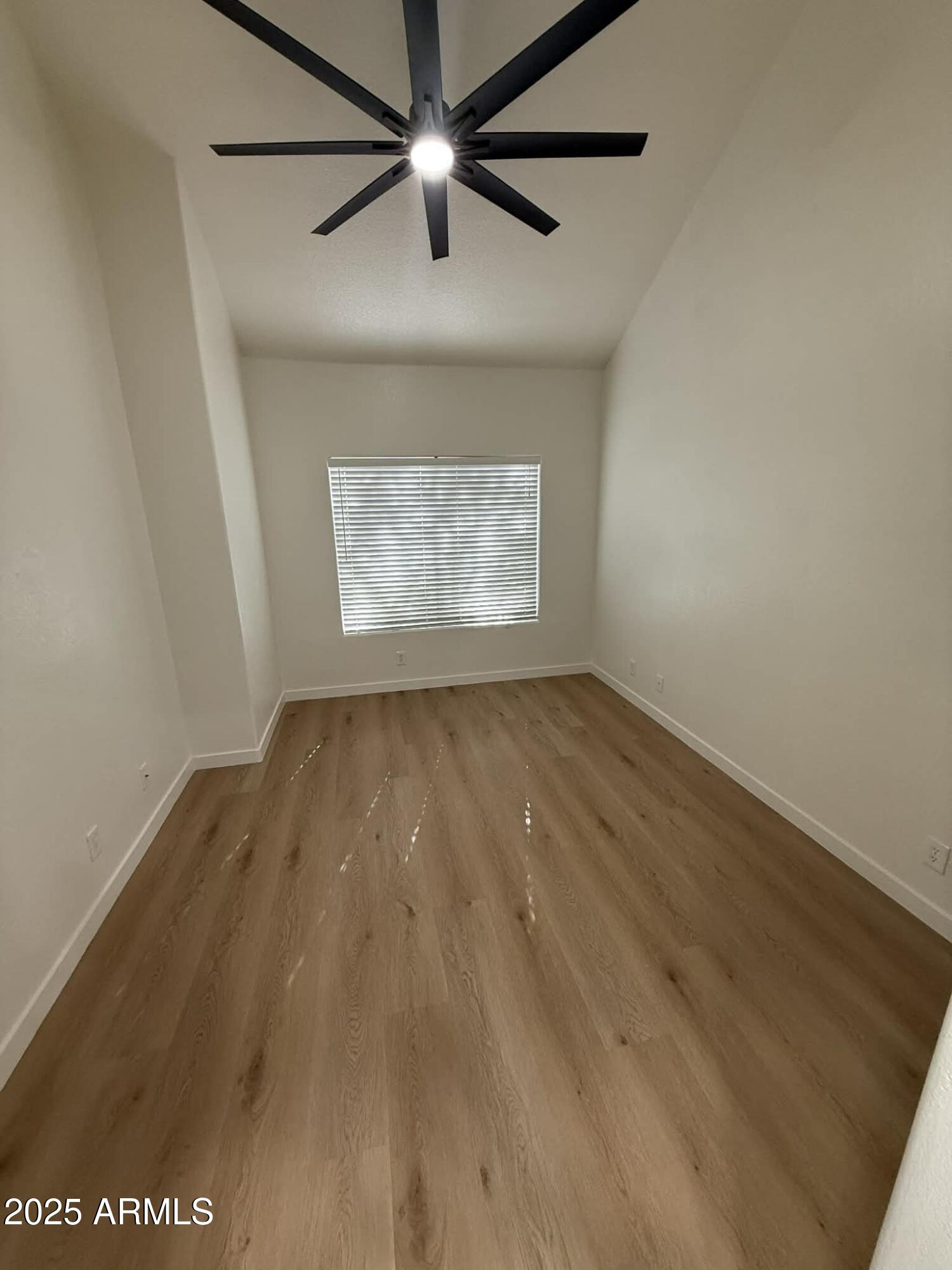1633 East Lakeside Drive, Unit 65 Gilbert, AZ 85234 - Photo 5 of 12 an empty room with wooden floor and windows