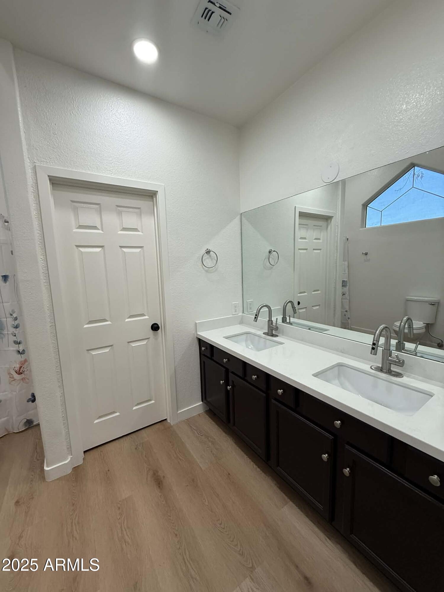 1633 East Lakeside Drive, Unit 65 Gilbert, AZ 85234 - Photo 7 of 12 a spacious bathroom with a double vanity sink and mirror