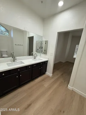 a spacious bathroom with a double vanity sink and mirror