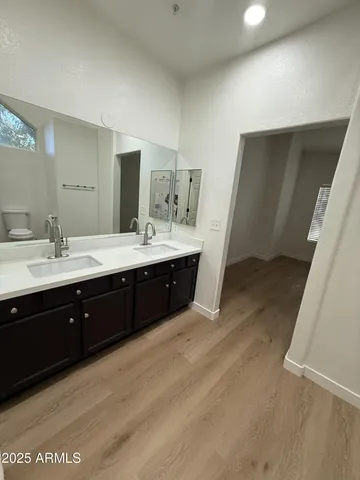 a spacious bathroom with a double vanity sink and mirror