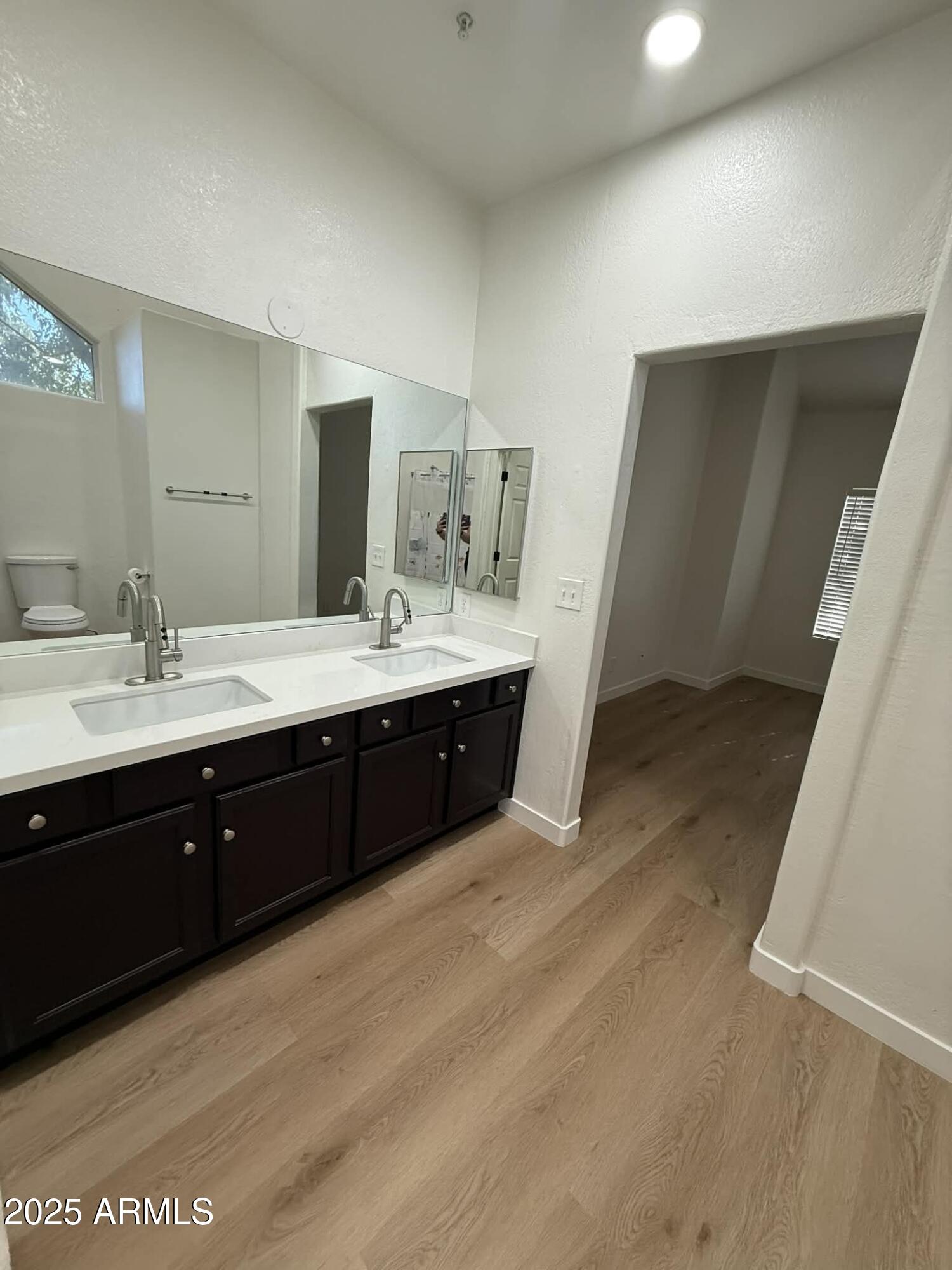 1633 East Lakeside Drive, Unit 65 Gilbert, AZ 85234 - Photo 9 of 12 a spacious bathroom with a double vanity sink and mirror