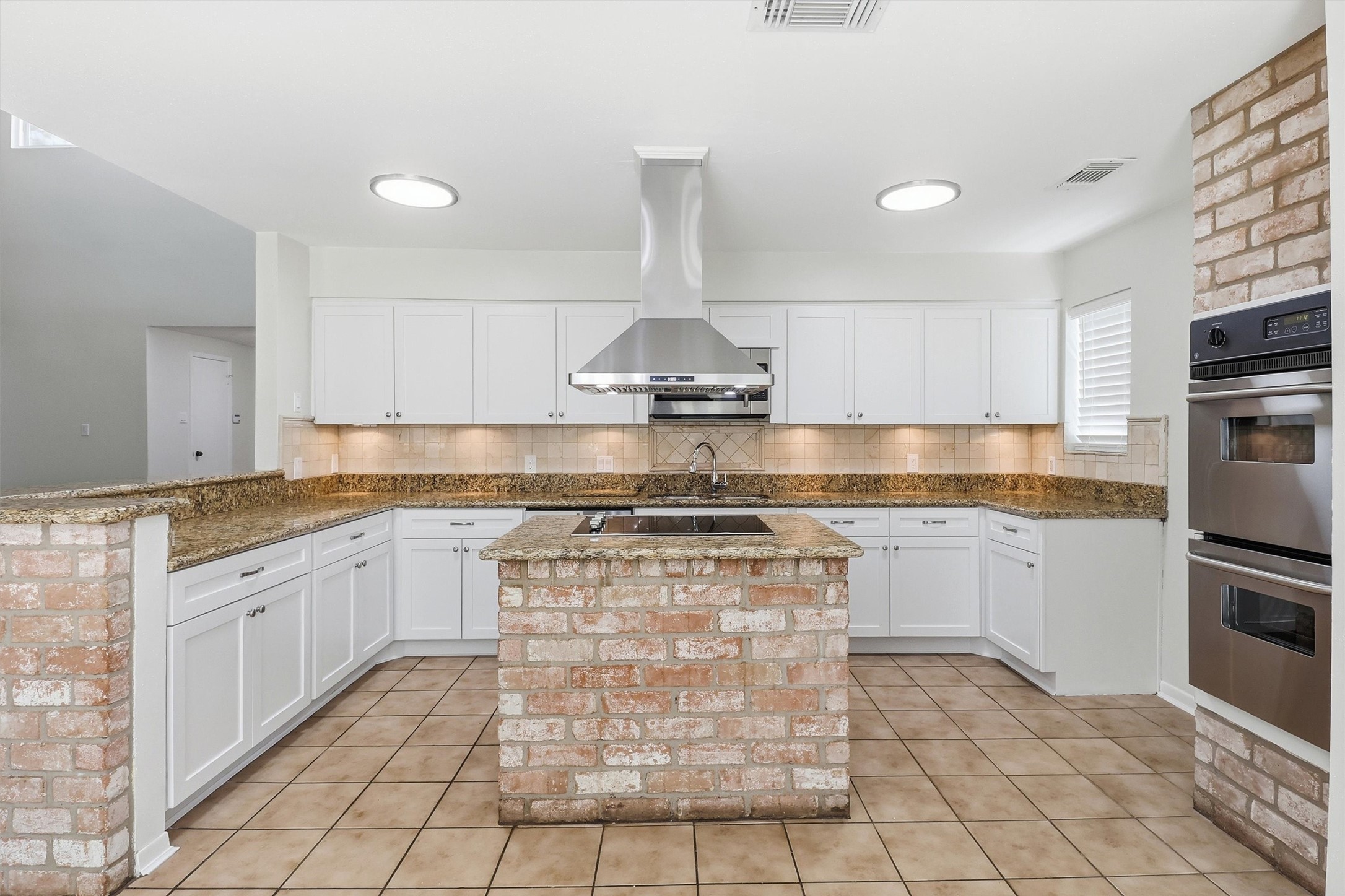 22411 Waynoka Road Katy, TX 77450 - Photo 10 of 34 New cooktop and island granite countertop with vent hood.