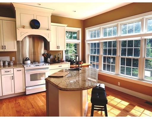 29 Beach Road Ware, MA 01082 - Photo 9 of 42 a kitchen with kitchen island a large window cabinets and stainless steel appliances
