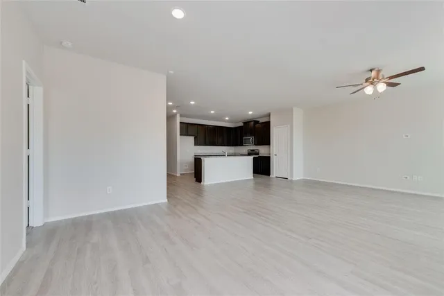 a view of a kitchen with a sink and a refrigerator