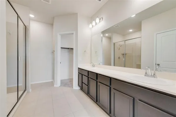 a bathroom with a glass shower door