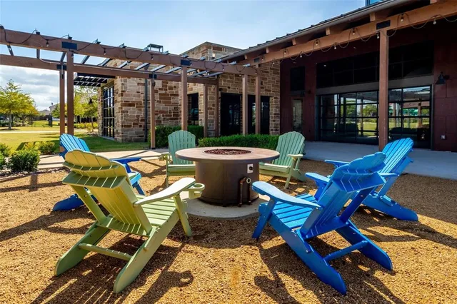a view of a house with swimming pool and sitting area