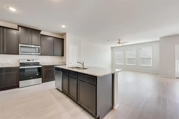 a kitchen with a sink appliances and cabinets