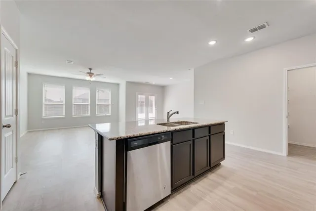 a kitchen with a sink and cabinets