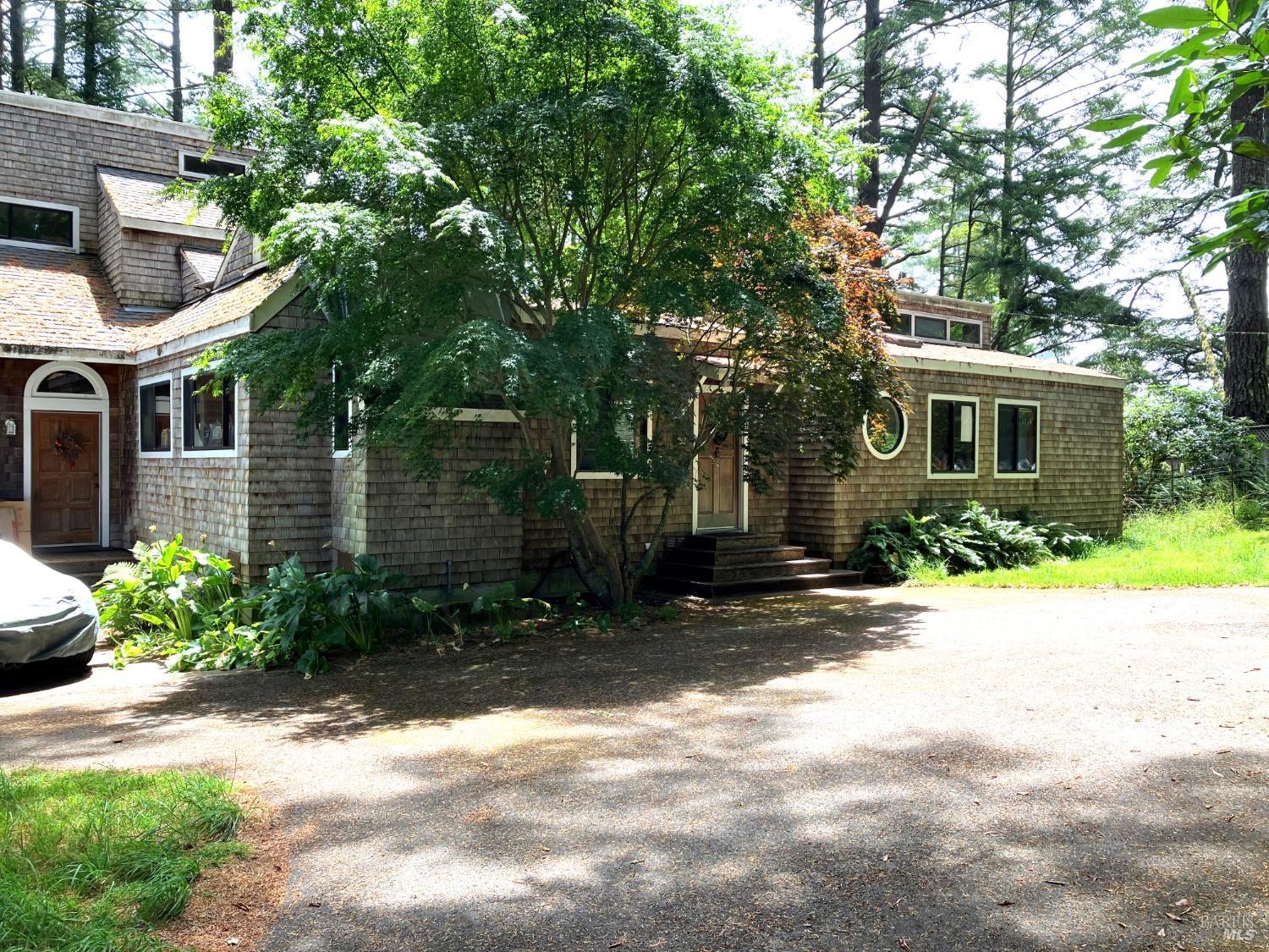 64 Drakes Summit Road Inverness, CA 94956 - Photo 1 of 1 a view of a patio with table and chairs and potted plants