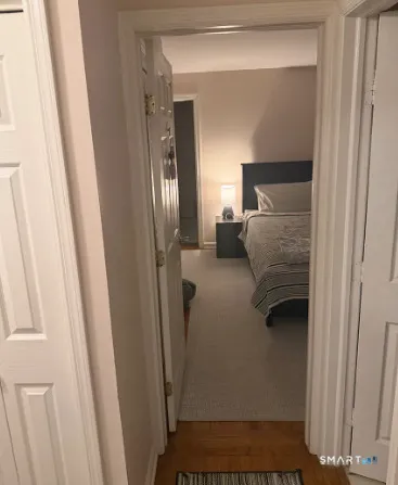 a bedroom with a bed and a mirror