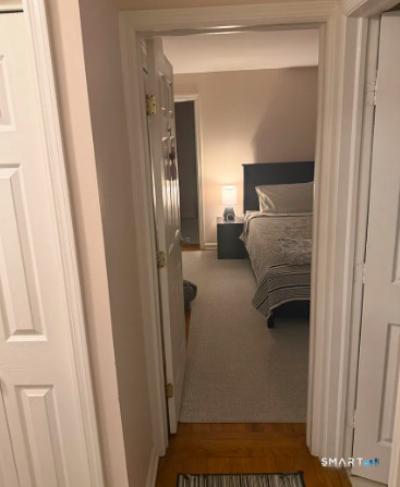 186 Seaton Road, Unit 2 Stamford, CT 06902 - Photo 11 of 14 a bedroom with a bed and a mirror