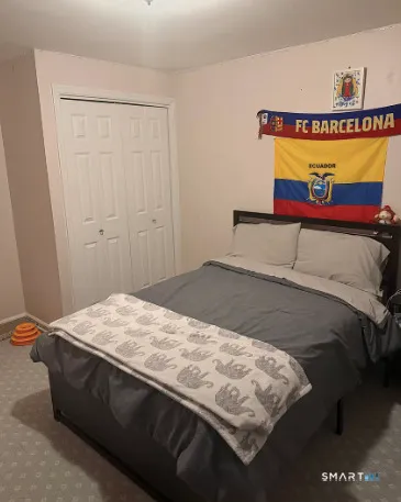 a bedroom with a bed and a table