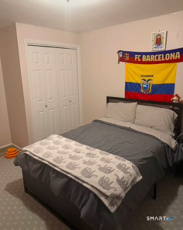 186 Seaton Road, Unit 2 Stamford, CT 06902 - Photo 12 of 14 a bedroom with a bed and a table