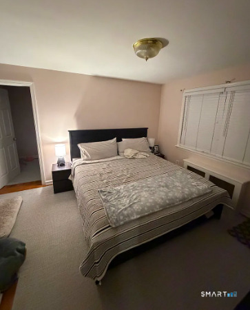 186 Seaton Road, Unit 2 Stamford, CT 06902 - Photo 14 of 14 a bedroom with a bed and a night stand