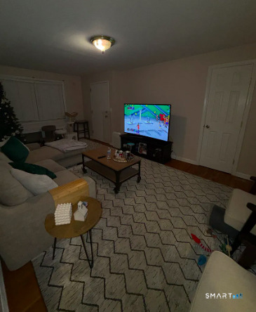 186 Seaton Road, Unit 2 Stamford, CT 06902 - Photo 3 of 14 a living room with furniture a rug and a wall painting